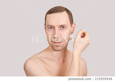 Man skin care routine. Oil pipette near male face. Hair serum product. Haircare 115970544