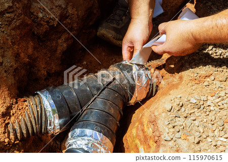 At trench installation of drainage pipe for draining rainwater 115970615