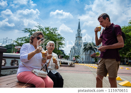 Senior adults in Cali Colombia eating the traditional Champus. Senior adults travelling togeher having fun.Senior lifestyle. Senior travel. Senior adults in Cali Colombia eating the traditional Champus. Senior adults travelling togeher having fun.Senior lifestyle. Senior travel. 115970651