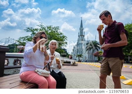 Senior adults in Cali Colombia eating the traditional Champus. Senior adults travelling togeher having fun.Senior lifestyle. Senior travel. Senior adults in Cali Colombia eating the traditional Champus. Senior adults travelling togeher having fun.Senior lifestyle. Senior travel. 115970653