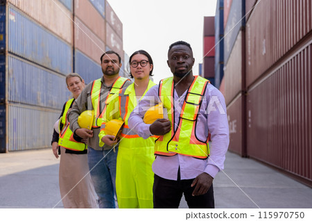Group of multi ethnic team of engineers and workers standing together with containers in shipping cargo yard. 115970750