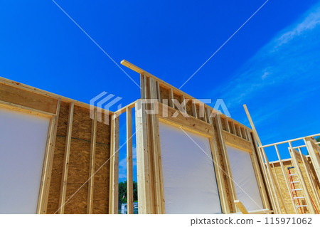 Building frame for unfinished interior timber support beams during construction of new building 115971062