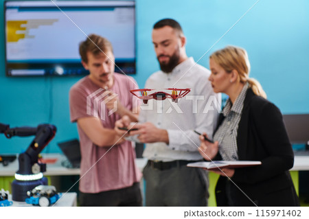 A group of students working together in a laboratory, dedicated to exploring the aerodynamic capabilities of a drone A group of students working together in a laboratory, dedicated to exploring the aerodynamic capabilities of a drone 115971402