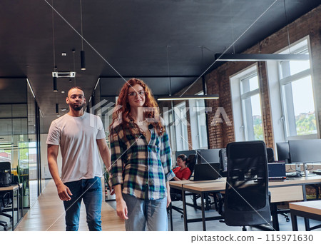 A young African American businessman and a modern businesswoman with orange hair stand side by side, arms crossed, exuding confidence and unity in a contemporary office setting, epitomizing dynamic 115971630