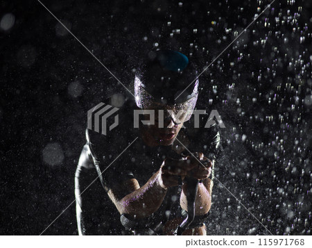 A triathlete braving the rain as he cycles through the night, preparing himself for the upcoming marathon. The blurred raindrops in the foreground and the dark, moody atmosphere in the background add A triathlete braving the rain as he cycles through the night, preparing himself for the upcoming marathon. The blurred raindrops in the foreground and the dark, moody atmosphere in the background add 115971768