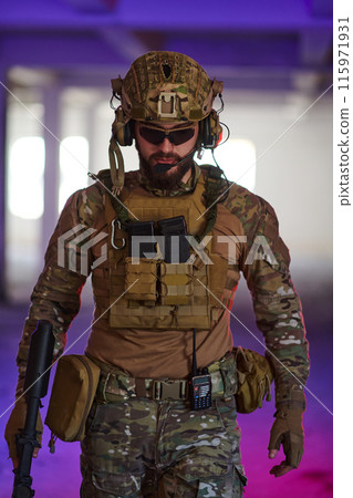 A professional soldier undertakes a perilous mission in an abandoned building illuminated by neon blue and purple lights 115971931