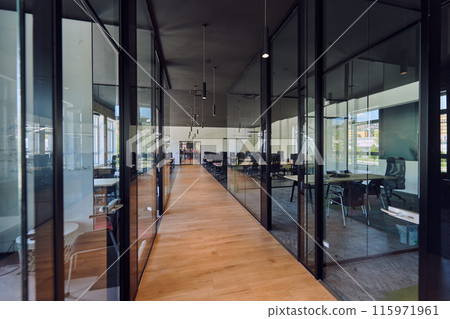 In a setting of modern, glass-walled business startup offices, the open, airy workspace reflects a contemporary and innovative ambiance, promising a dynamic environment for entrepreneurial growth 115971961