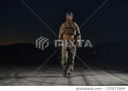 A professional soldier in full military gear striding through the dark night as he embarks on a perilous military mission A professional soldier in full military gear striding through the dark night as he embarks on a perilous military mission 115971984