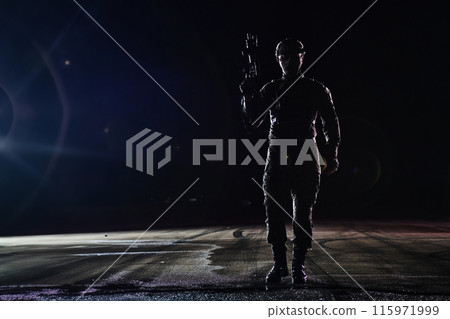 A professional soldier in full military gear striding through the dark night as he embarks on a perilous military mission A professional soldier in full military gear striding through the dark night as he embarks on a perilous military mission 115971999