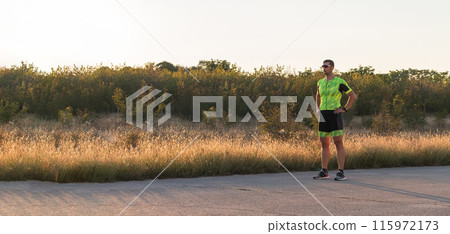 A triathlete resting after a hard morning's run. Training preparation for the upcoming marathon A triathlete resting after a hard morning's run. Training preparation for the upcoming marathon 115972173