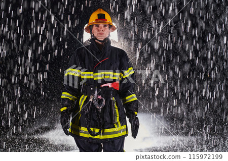 A determined female firefighter in a professional uniform striding through the dangerous, rainy night on a daring rescue mission, showcasing her unwavering bravery and commitment to saving lives. A determined female firefighter in a professional uniform striding through the dangerous, rainy night on a daring rescue mission, showcasing her unwavering bravery and commitment to saving lives. 115972199
