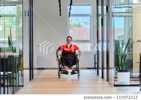A modern young businesswoman in a wheelchair is surrounded by an inclusive workspace with glass-walled offices, embodying determination and innovation in the business world A modern young businesswoman in a wheelchair is surrounded by an inclusive workspace with glass-walled offices, embodying determination and innovation in the business world 115972212