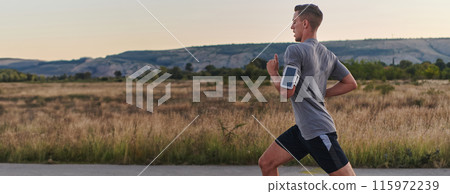 A young handsome man running in the early morning hours, driven by his commitment to health and fitness 115972239