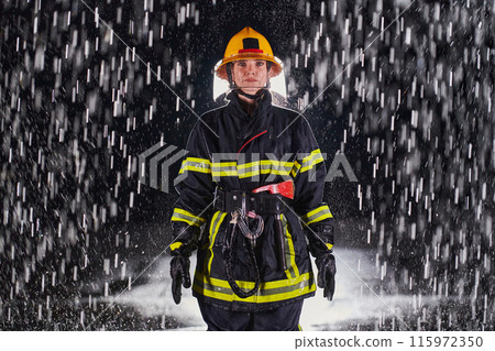 A determined female firefighter in a professional uniform striding through the dangerous, rainy night on a daring rescue mission, showcasing her unwavering bravery and commitment to saving lives. 115972350