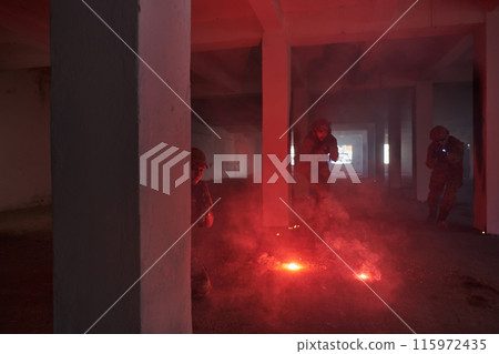 A group of professional soldiers bravely executes a dangerous rescue mission, surrounded by fire in a perilous building. 115972435