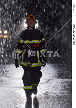 A determined female firefighter in a professional uniform striding through the dangerous, rainy night on a daring rescue mission, showcasing her unwavering bravery and commitment to saving lives. A determined female firefighter in a professional uniform striding through the dangerous, rainy night on a daring rescue mission, showcasing her unwavering bravery and commitment to saving lives. 115972482