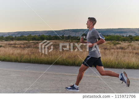 A young handsome man running in the early morning hours, driven by his commitment to health and fitness 115972706