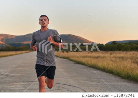 A young handsome man running in the early morning hours, driven by his commitment to health and fitness 115972741