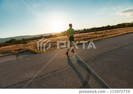 Triathlete in professional gear running early in the morning, preparing for a marathon, dedication to sport and readiness to take on the challenges of a marathon. Triathlete in professional gear running early in the morning, preparing for a marathon, dedication to sport and readiness to take on the challenges of a marathon. 115972759