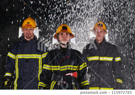 A group of professional firefighters marching through the rainy night on a rescue mission, their determined strides and fearless expressions reflecting their unwavering bravery and unwavering A group of professional firefighters marching through the rainy night on a rescue mission, their determined strides and fearless expressions reflecting their unwavering bravery and unwavering 115972783