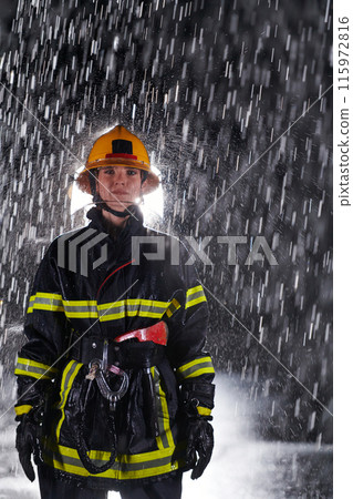 A determined female firefighter in a professional uniform striding through the dangerous, rainy night on a daring rescue mission, showcasing her unwavering bravery and commitment to saving lives. 115972816