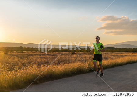 Triathlete in professional gear running early in the morning, preparing for a marathon, dedication to sport and readiness to take on the challenges of a marathon.  115972959