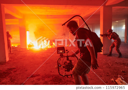 A professional cameraman captures the intense moments as a group of skilled soldiers embarks on a dangerous mission inside an abandoned building, their actions filled with suspense and bravery 115972965