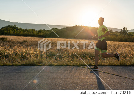 Triathlete in professional gear running early in the morning, preparing for a marathon, dedication to sport and readiness to take on the challenges of a marathon.  115973216