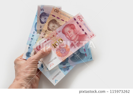 Many of different Chinese yuan banknotes. Chinese paper currency Yuan renminbi banknotes on white background. Copy space. View from above. 115973262