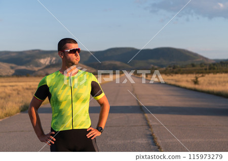 Triathlete resting after exhausting training for the upcoming marathon. Triathlete resting after exhausting training for the upcoming marathon. 115973279