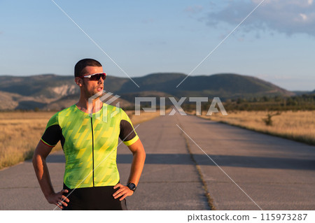 Triathlete resting after exhausting training for the upcoming marathon. Triathlete resting after exhausting training for the upcoming marathon. 115973287