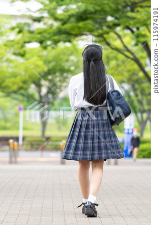 Back view of a school girl in uniform Back view of a school girl in uniform 115974191