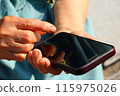 My mother's hands operating a smartphone 115975026