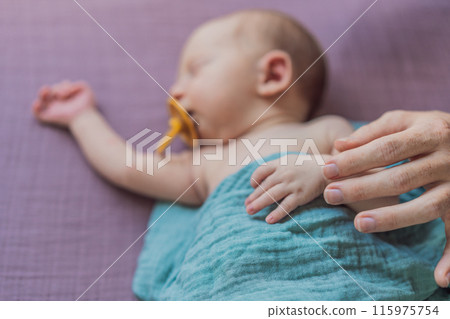 The baby is sleeping peacefully in his cozy nest. Newborn photo session captures the serene innocence and warmth of early moments The baby is sleeping peacefully in his cozy nest. Newborn photo session captures the serene innocence and warmth of early moments 115975754