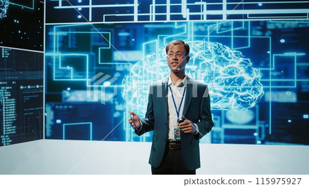 Jolly engineer using artificial intelligence computing simulating human brain thought processes. Portrait of upbeat Indian employee working with AI machine learning algorithms, camera B 115975927