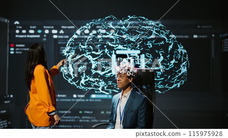 Company CEO using summit as platform to launch latest AI EEG headset product. Neuroscientist doing demonstration at forum in front of business leaders interested in artificial intelligence, camera B Company CEO using summit as platform to launch latest AI EEG headset product. Neuroscientist doing demonstration at forum in front of business leaders interested in artificial intelligence, camera B 115975928