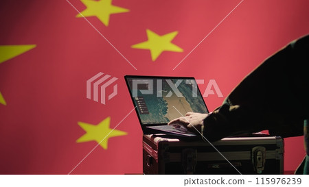 Chinese soldier in command control room using military tech to identify threats from enemies. Army personnel using software on laptop to communicate information to generals on war front line, camera B 115976239