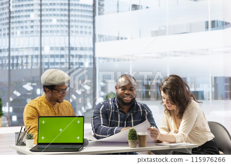 Real estate agent reviewing blueprints with entrepreneurs next to copy space, securing a contract with business partners looking to relocate their office space. High class urban building property. 115976266