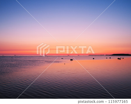 Cape Soya in early spring: the calm sea bathed in the morning glow 115977165