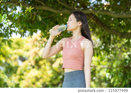 Woman hydrating in green park (outdoor portrait, resting, relaxing) Woman hydrating in green park (outdoor portrait, resting, relaxing) 115977499