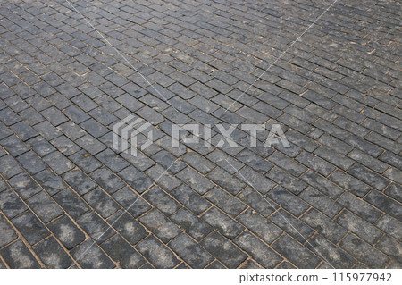 Abstract background of old cobblestone pavement close-up. Abstract background of old cobblestone pavement close-up. 115977942