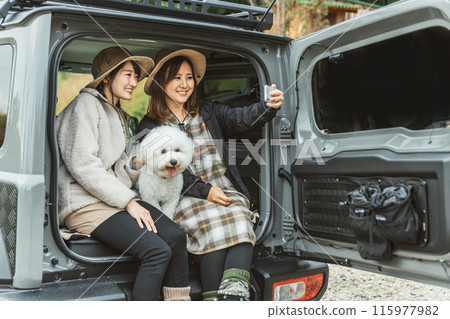 Women, friends, best friends in outdoor fashion driving with their pet dog Women, friends, best friends in outdoor fashion driving with their pet dog 115977982