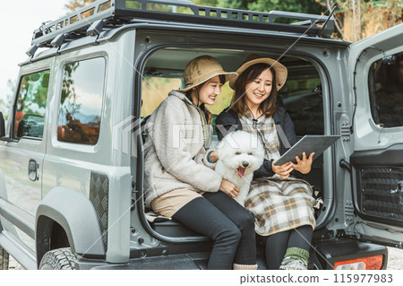 Women, friends, best friends in outdoor fashion driving with their pet dog Women, friends, best friends in outdoor fashion driving with their pet dog 115977983
