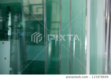 Row of finished window glass in an industrial workshop closeup Row of finished window glass in an industrial workshop closeup 115978649