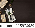 Christmas dinner concept. Forks with a knife on a napkin and Christmas decorations made from natural materials on a dark wooden table. Top view, flat lay. 115978689