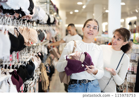 Two women choosing convenient bra in clothing store 115978753