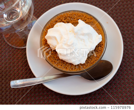 Baked sweet dessert coffee mousse made from fermented milk product, decorated by whipped cream 115978976
