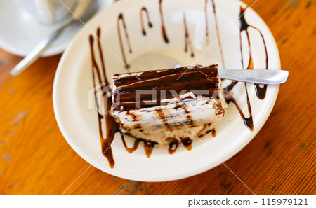 Ice cream dessert with chocolate crust 115979121