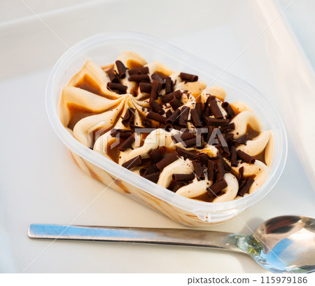 Large portion of ice cream packed in disposable container 115979186