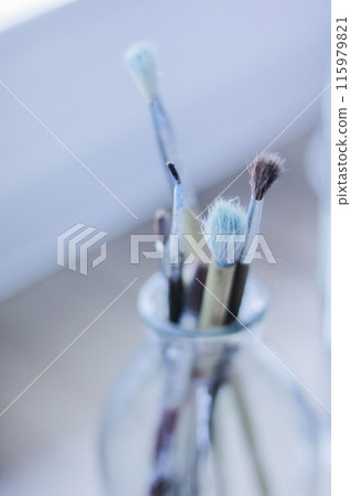 Brushes standing in a bottle 115979821